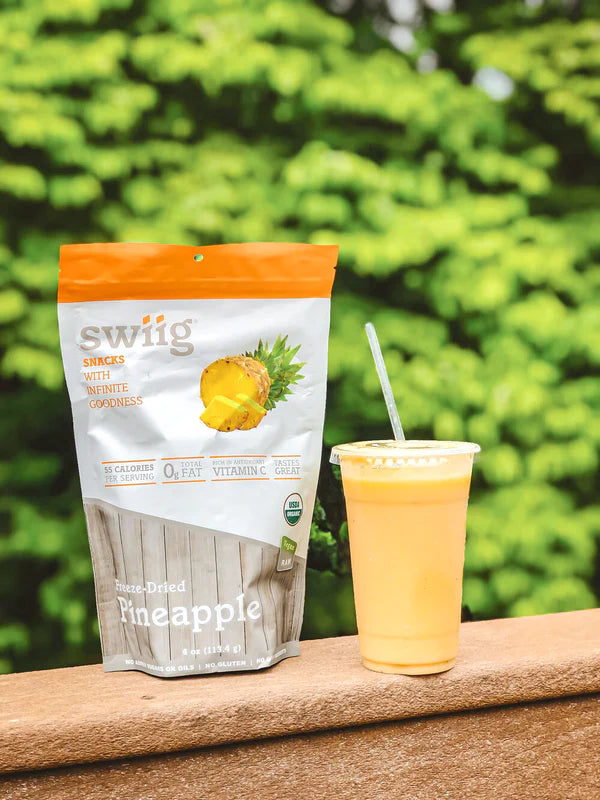 swiig freeze dried powder with a pineapple shake in a cup