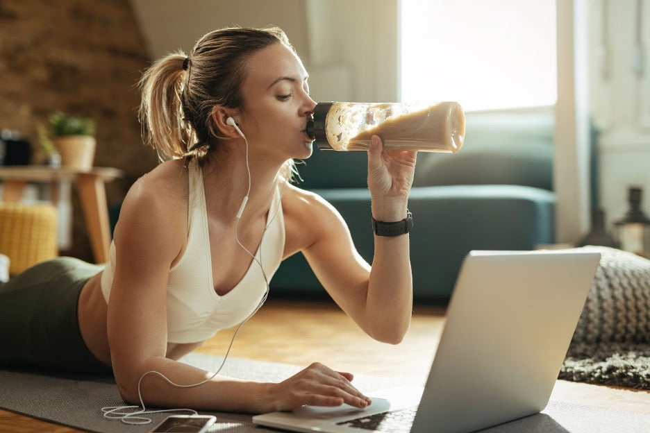 A person drinking a meal replacement shake while researching: Do meal replacement shakes work?